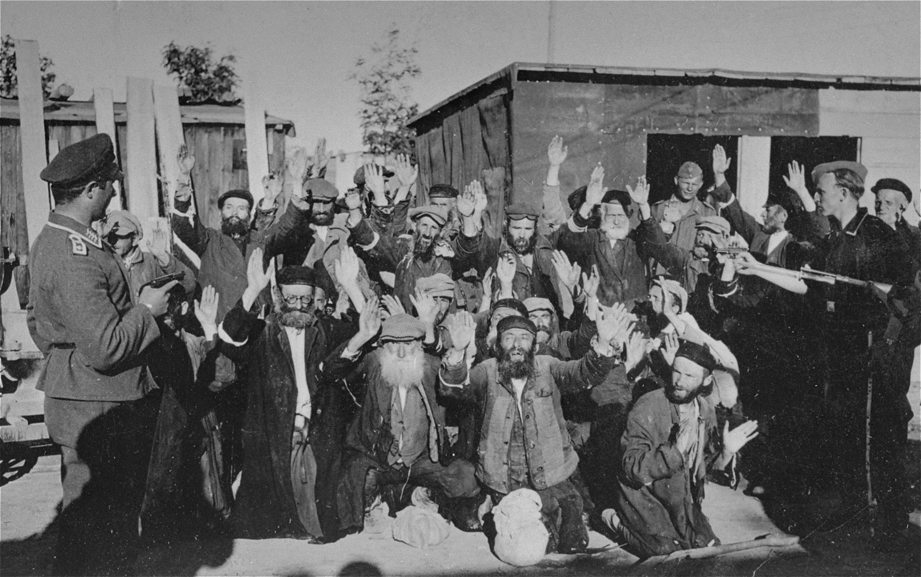 Jews on their knees at Nazi gun point